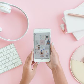 women holding iphone with instagram grid